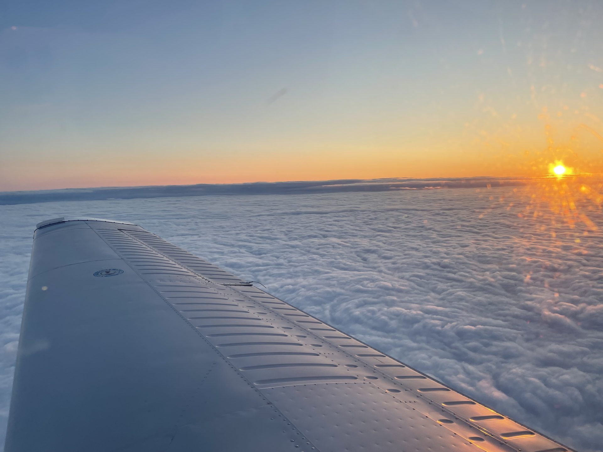 Above the clouds at sunset